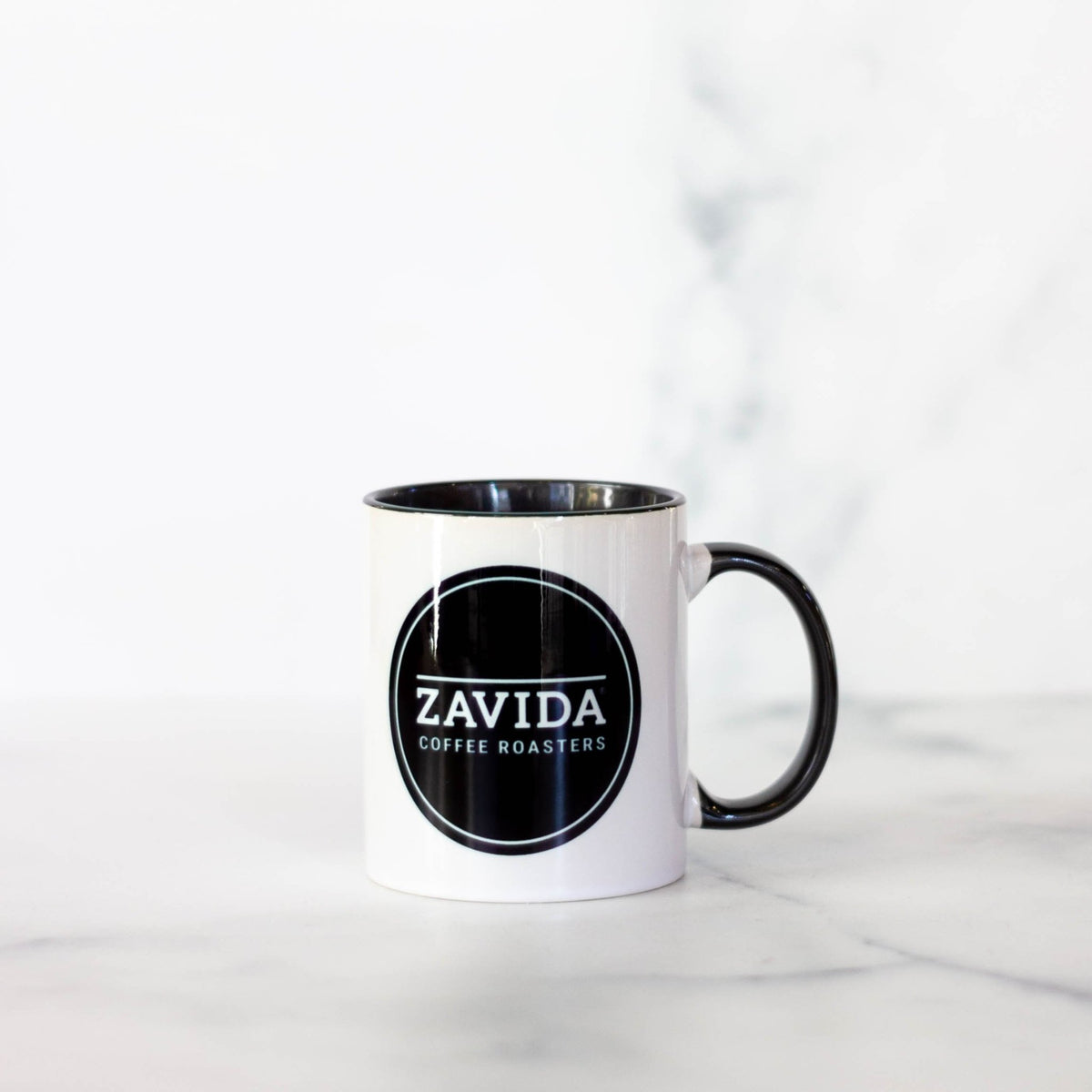 Zavida Coffee Roasters white coffee mug with a black logo
